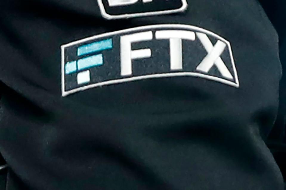 The FTX logo appears on an umpire's jacket at a Minnesota Twins baseball game in September.