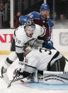 Los Angeles Kings defenseman Sean Durzi, center, falls over goaltender Jonathan Quick, below, as he is pushed by Colorado Avalanche defenseman Kurtis MacDermid during the third period of an NHL hockey game Thursday, Jan. 20, 2022, in Los Angeles. (AP Photo/Mark J. Terrill)