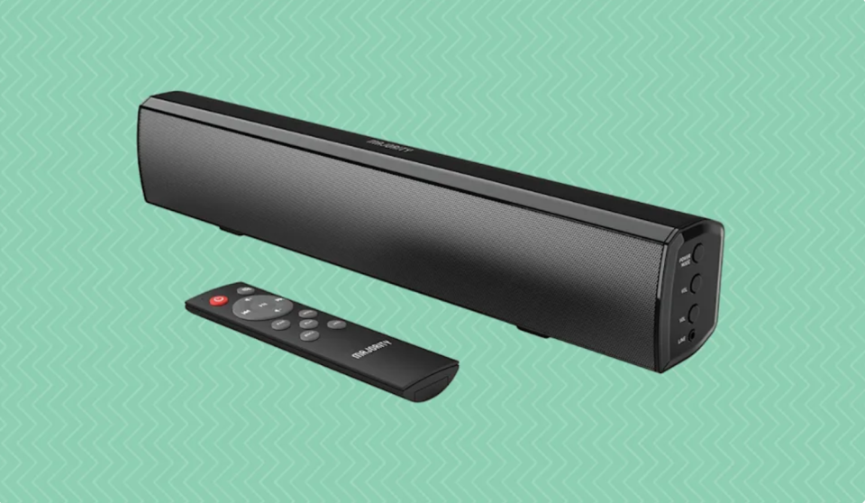 A long black sound bar with a small black remote next to it