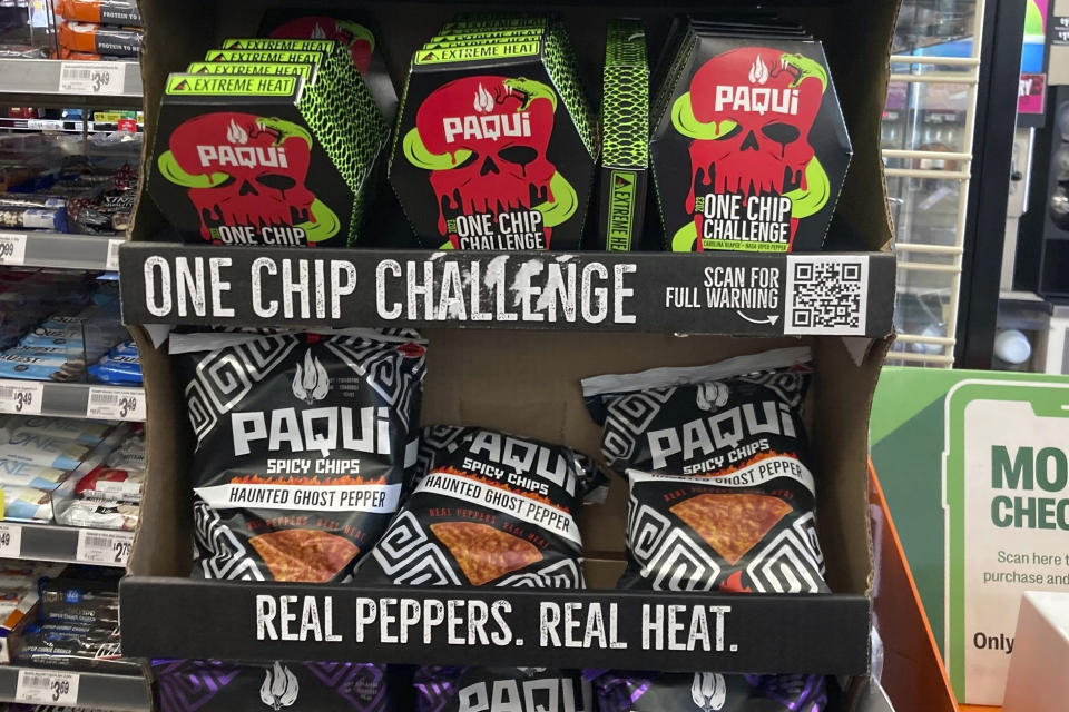 FILE - Paqui One Chip Challenge chips are displayed at a 7-Eleven store in Boston, Thursday, Sept. 7, 2023, before they were removed the following day. A medical examiner says a Massachusetts teen who participated in a spicy tortilla chip challenge died from ingesting a substance “with a high capsaicin concentration,” according to autopsy results The Associated Press obtained late Wednesday, May 15, 2024. Capsaicin is a chili pepper extract. Harris Wolobah died on Sept. 1, 2023, after eating the chip. (AP Photo/Steve LeBlanc, File)