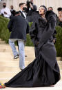 <p>Ganz in Schwarz und ausgesprochen voluminös war das Kleid, das sich Rihanna für ihren großen Auftritt bei der Met Gala 2021 ausgesucht hatte. Zum aufregenden Mix aus Robe und Mantel von Balenciaga Couture kombinierte sie stilsicher eine simple Beanie-Mütze, die in schönem Kontrast zum juwelenverzierten Kopfschmuck von Maria Tash Jewelry stand. (Bild: Getty Images)</p> 