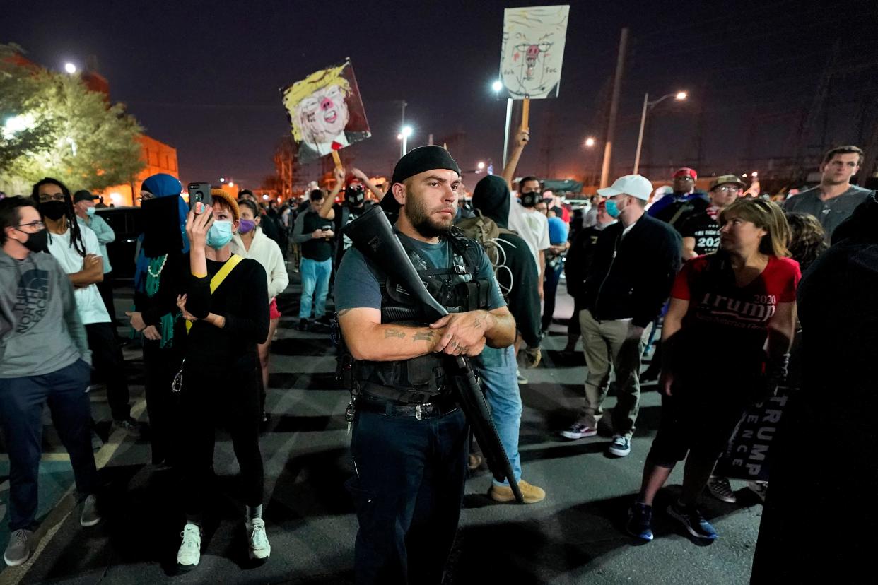 <p>Trump supporters rally outside the Maricopa County Recorder's Office on Wednesday night</p> (AP)