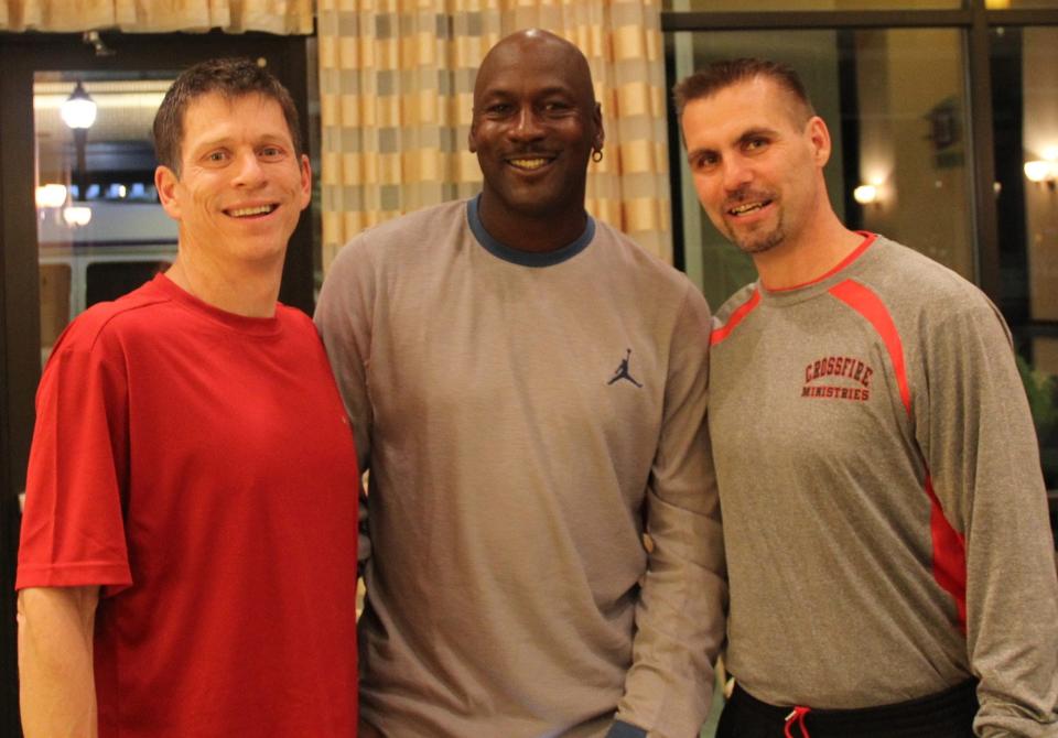 Crossfire Ministries' co-founders Jamie Johnson, left, and Randy Shepherd, right, pose with NBA Hall of Famer Michael Jordan.