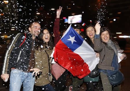 Chilean fans celebrate their team defeating Argentina to win the Copa America 2015 final soccer match at the National Stadium in Santiago, Chile, July 4, 2015. REUTERS/Rodrigo Garrido