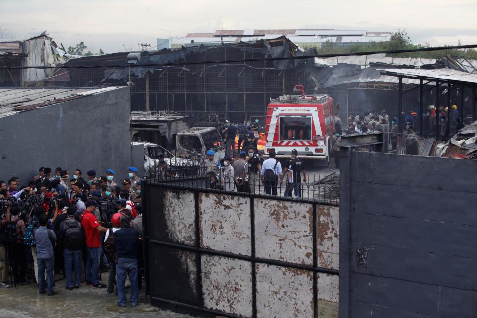 <p>Indonesian police officer evacuated a body bag containing the bodies of fire victims at a fireworks factory in Tangerang, Indonesia, on Oct. 26, 2017. (Photo: Agoes Rudianto/Anadolu Agency/Getty Images) </p>