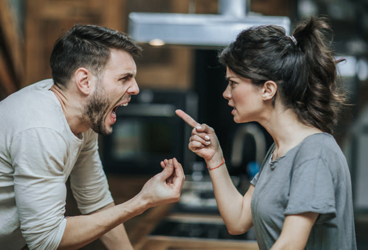 Man screaming at a woman who is pointing her finger at him