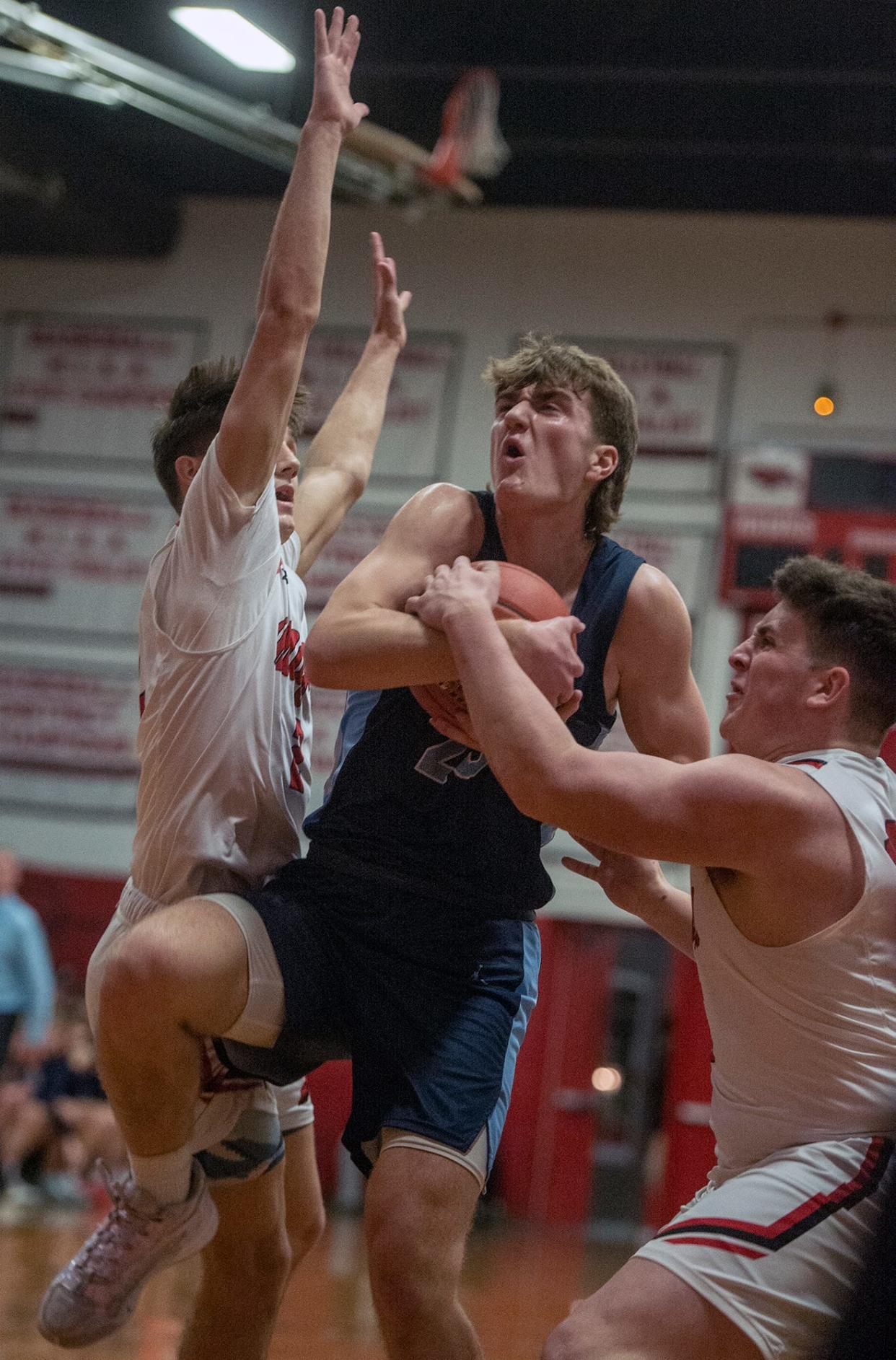 Franklin High School senior Sean O'Leary fights his way the hoop at Milford, Jan. 26, 2024.