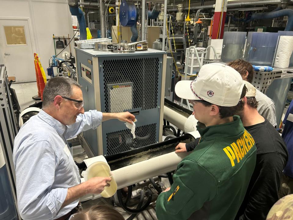David Powling, left, shows plumbing students from Fox Valley Technical College how wipes break down in tests at Kimberly-Clark's Flushability Lab in Neenah, Wisc., on Jan. 25.