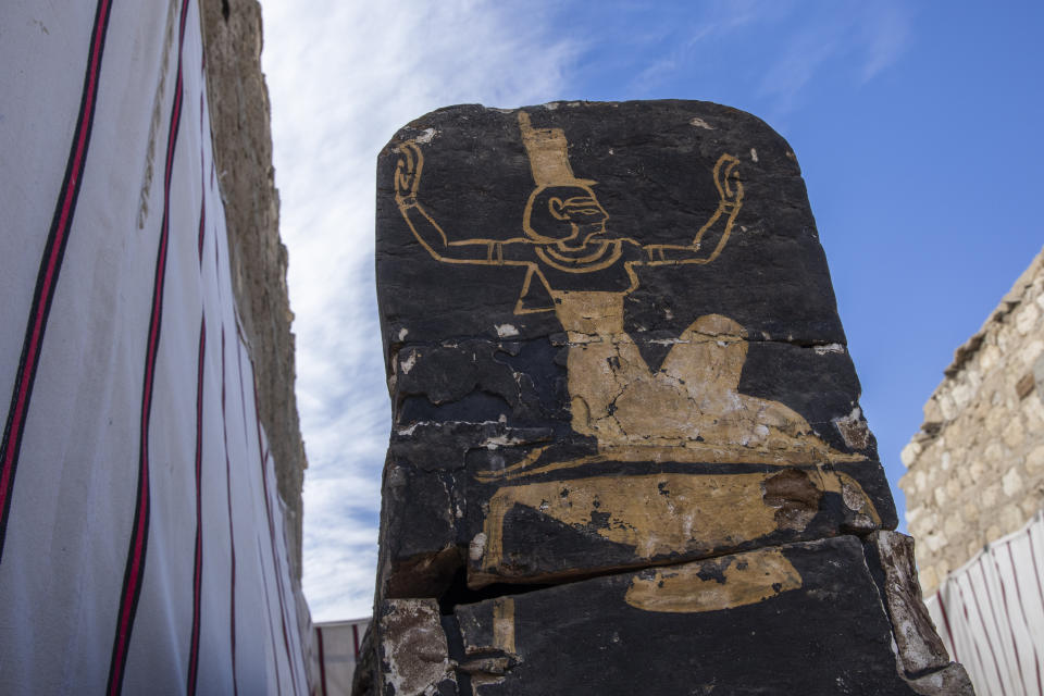 An ancient coffin is on display that Egyptian archaeologist Zahi Hawass and his team unearthed in a vast necropolis filled with burial shafts, coffins and mummies dating back to the New Kingdom 3000 BC, Sunday, Jan. 17, 2021, in Saqqara, south of Cairo, Egypt. (AP Photo/Nariman El-Mofty)