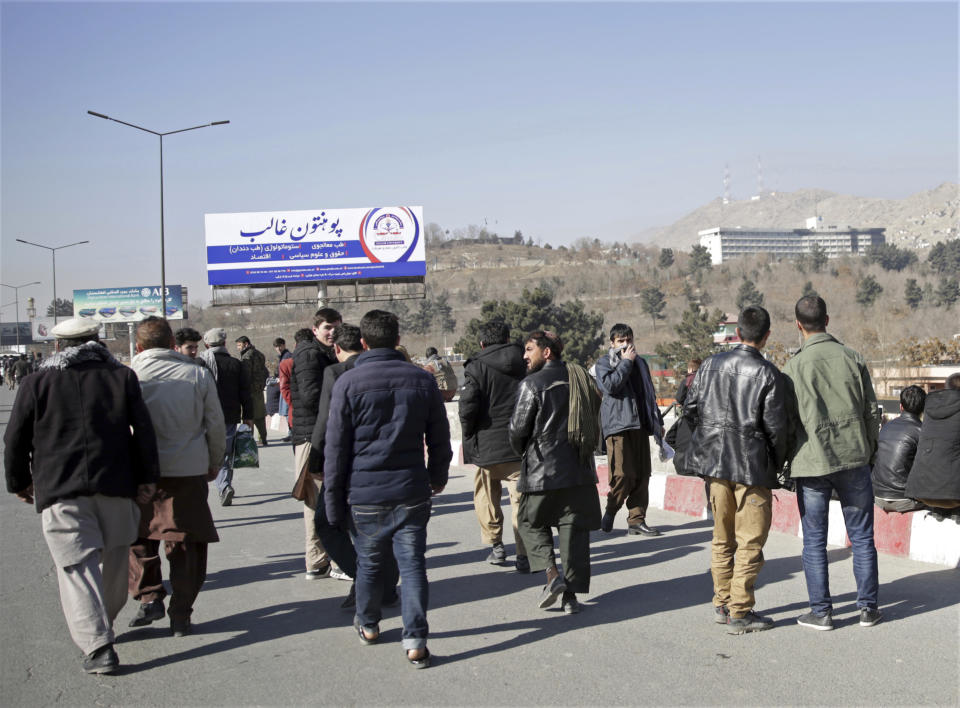 <p>Residents watch an attack on the Intercontinental Hotel, in Kabul, Afghanistan, Jan. 21, 2018. (Photo: Massoud Hossaini/AP) </p>