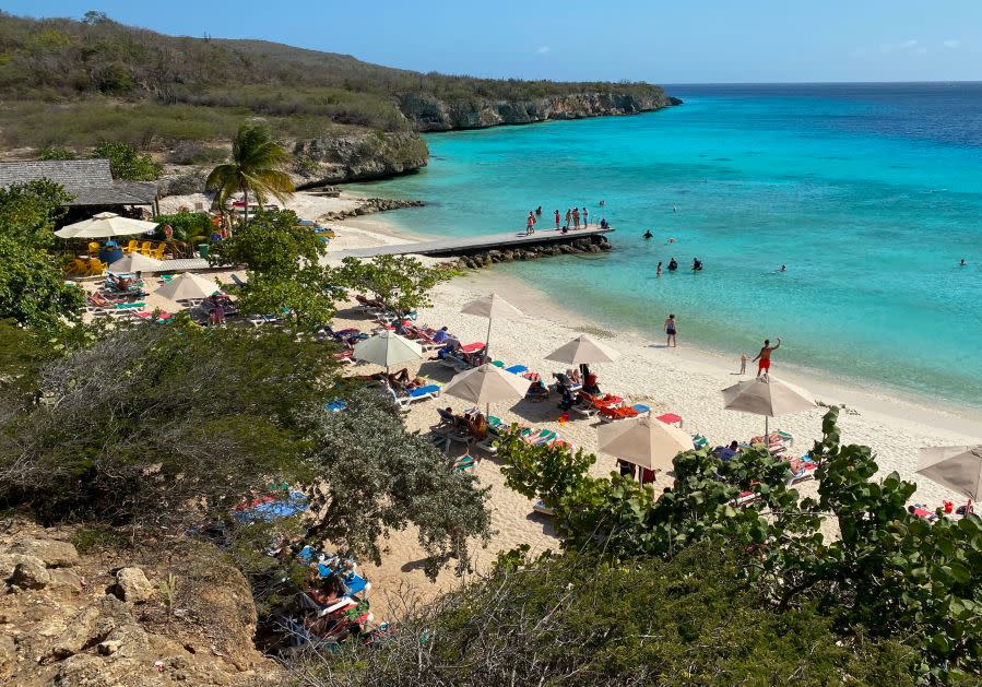 People enjoy Porto Marie beach north-west of Willemstad, Curacao, in the Dutch Caribbean, on March 4, 2020. (Photo by Daniel SLIM / AFP) (Photo by DANIEL SLIM/AFP via Getty Images)