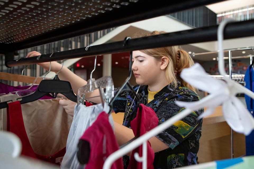 Jayda Puhn organizes prom dresses Friday during a prom dress giveaway at North Eugene High School.