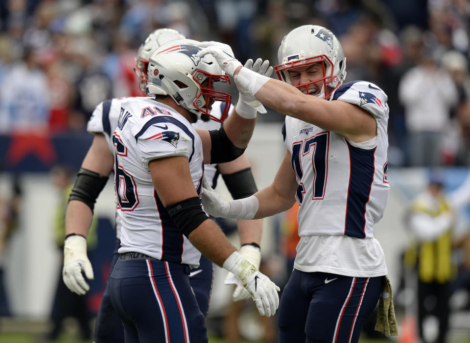New England Patriots fullback James Develin (46) celebrates with tight end Jacob Hollister (47) after Develin scored a touchdown on a 1-yard run against the Tennessee Titans in the first half of an NFL football game Sunday, Nov. 11, 2018, in Nashville, Tenn. (AP Photo/Mark Zaleski)