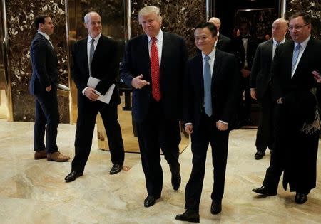U.S. President-elect Donald Trump walks from an elevator with Alibaba executive chairman Jack Ma after their meeting at Trump Tower in New York, U.S., January 9, 2017. REUTERS/Mike Segar