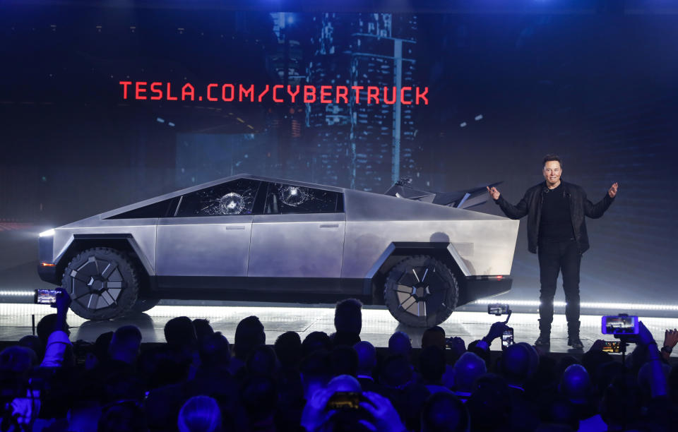 FILE - In this Nov. 21, 2019 file photo, Tesla CEO Elon Musk introduces the Cybertruck at Tesla's design studio in Hawthorne, Calif.  The much-hyped unveil of Tesla’s electric pickup truck went off script Thursday night when supposedly unbreakable window glass shattered twice when hit with a large metal ball. The failed stunt, which ranks high on the list of embarrassing auto industry rollouts, came just after Musk bragged about the strength of “Tesla Armor Glass” on the wedge-shaped “Cybertruck.” (AP Photo/Ringo H.W. Chiu, File)