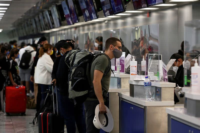 FILE PHOTO: Passengers check-in at airline counters at the Miguel Hidalgo y Costilla International Airport, operated by Mexican airport operator Grupo Aeroportuario del Pacifico (GAP), in Guadalajara