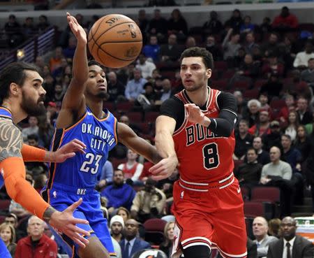 Dec 7, 2018; Chicago, IL, USA; Chicago Bulls guard Zach LaVine (8) passes the ball around Oklahoma City Thunder guard Terrance Ferguson (23) during the first quarter at United Center. David Banks-USA TODAY Sports
