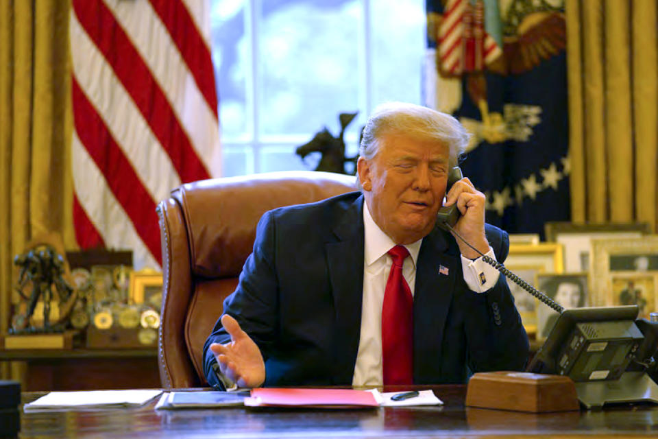 In this image released in the final report by the House select committee investigating the Jan. 6 attack on the U.S. Capitol, on Thursday, Dec. 22, 2022, President Donald Trump talks on the phone to Vice President Mike Pence from the Oval Office of the White House on Jan. 6, 2021. (House Select Committee via AP)