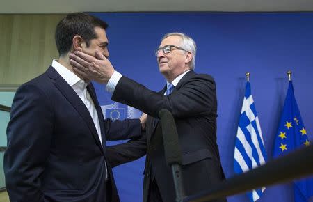 Greek Prime Minister Alexis Tsipras (L) is welcomed by European Commission President Jean-Claude Juncker for a meeting ahead of a Eurozone emergency summit on Greece in Brussels, Belgium June 22, 2015. REUTERS/Yves Herman