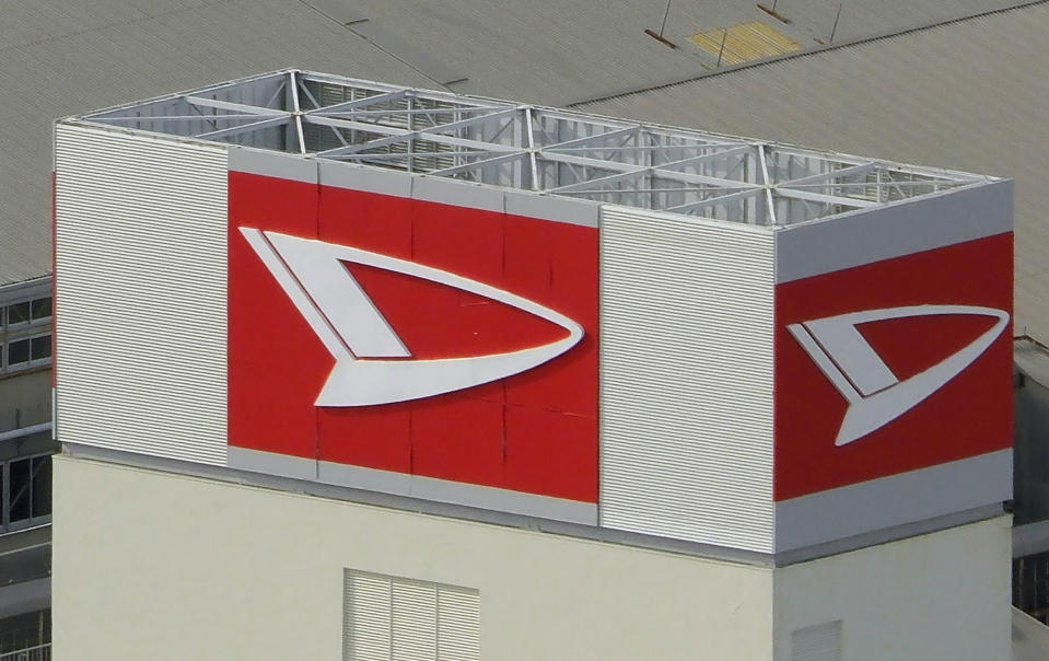 This aerial photo shows the logo of Daihatsu Motor at its headquarters in Ikeda, Osaka, Wednesday, Dec. 20, 2023. Toyota Motor Corp. said it's subsidiary Daihatsu will suspend shipments of all of its vehicles in and outside of Japan in a safety data fabrication scandal after an investigation found issues with 64 models that included Toyota and other brands. (Kyodo News via AP)