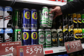 File photo dated 02/09/2010 of cans of lager and cider on the shelves in an off-licence. Ministers met the drinks industry dozens of times before ditching plans for minimum alcohol pricing, an investigation has found. PRESS ASSOCIATION Photo. Issue date: Wednesday January 8, 2014. It has prompted health experts to accuse the Government of