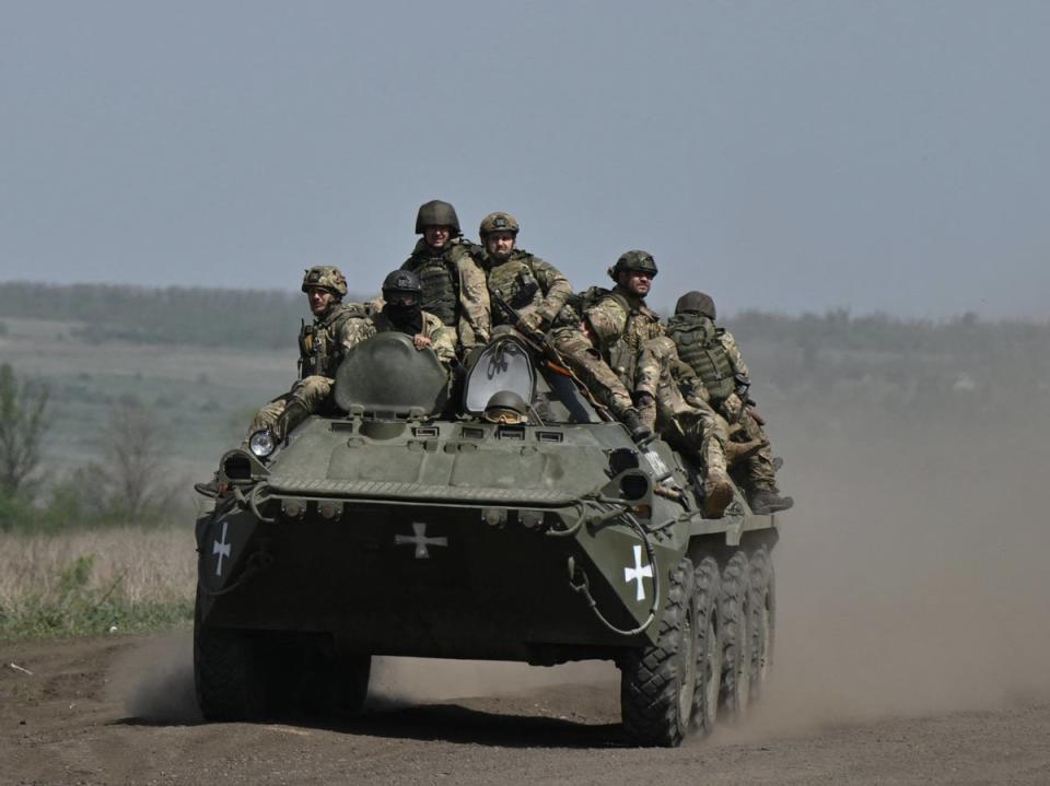 Ukrainian servicemen ride on an armored personnel carrier (APC) in a field near Chasiv Yar, Donetsk region (AFP via Getty Images)