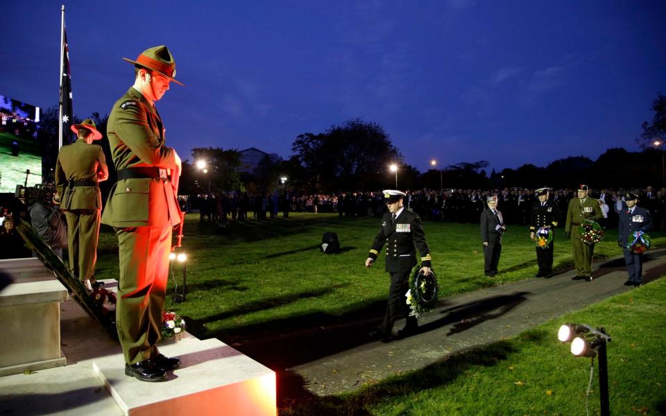 Military personnel prepare to lay wreaths at the cenotaph during the ANZAC Day dawn service in Christchurch, New Zealand - Credit: Mark Baker/AP