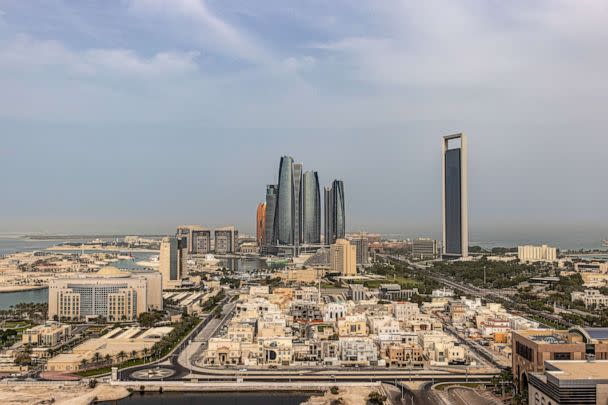 PHOTO: The headquarters of the Abu Dhabi National Oil Co. (ADNOC), right, and Etihad Towers, center, surrounded by residential and commercial properties in Abu Dhabi, United Arab Emirates, April 10, 2022. (Bloomberg via Getty Images)