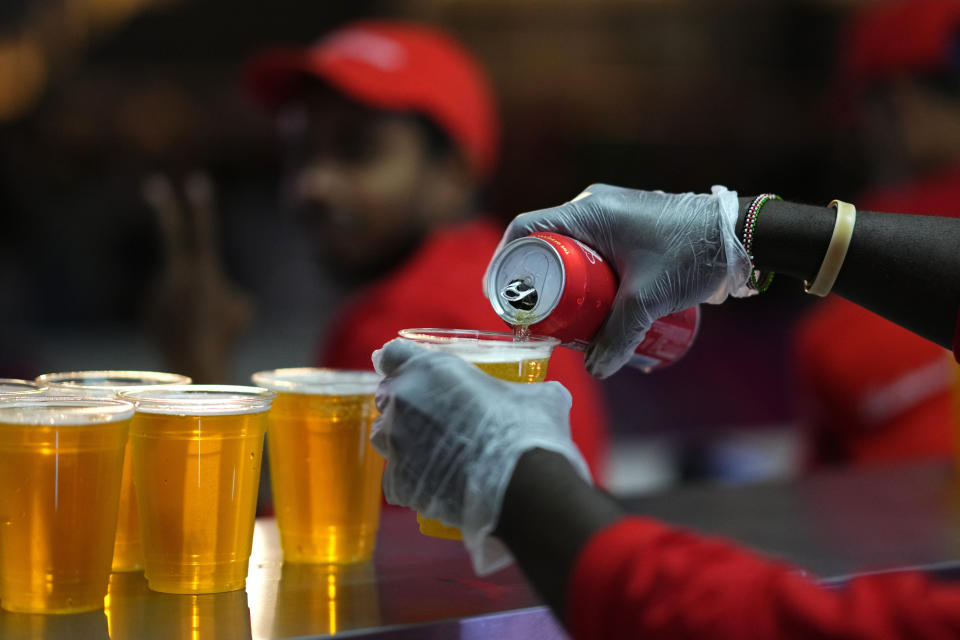 FILE - Staff member pours a beer at a fan zone ahead of the FIFA World Cup, in Doha, Qatar Saturday, Nov. 19, 2022. (AP Photo/Petr Josek)