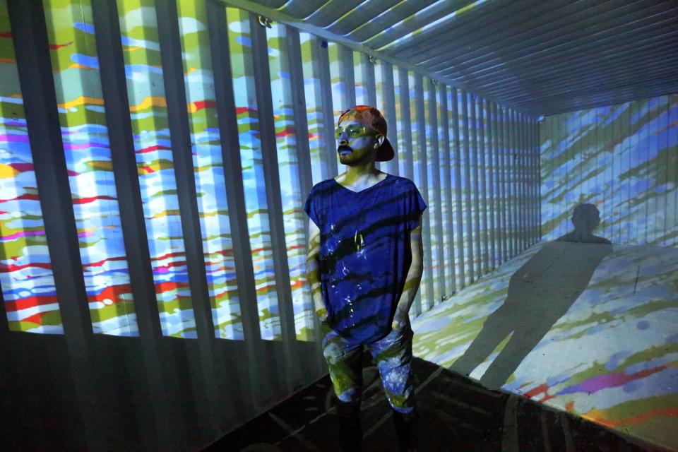 Artist David Delgado tests the projection system for his exhibit titled "Synesthesiac," housed inside a shipping container at Paradox Immersive Art at 3915 Rosa Ave. on Wednesday.