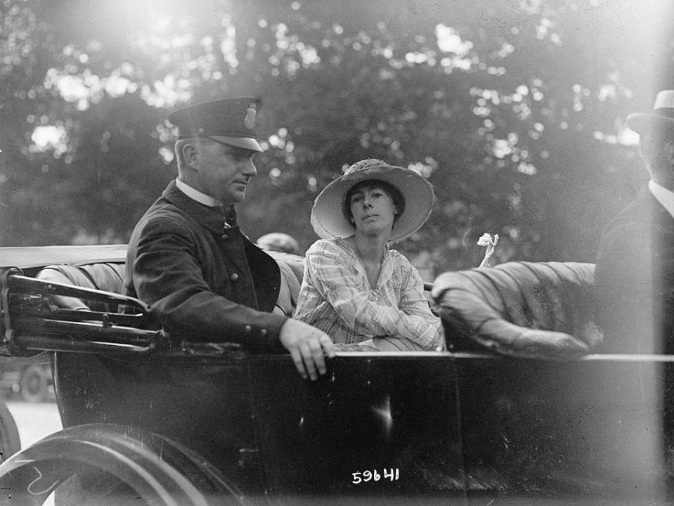 Katherine Morey on the way to police station with a Washington policeman.