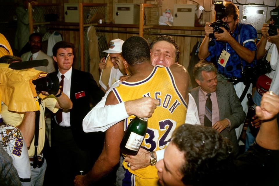 Coach Pat Riley and Magic Johnson embrace during the locker-room celebration capturing the 1988 NBA title.