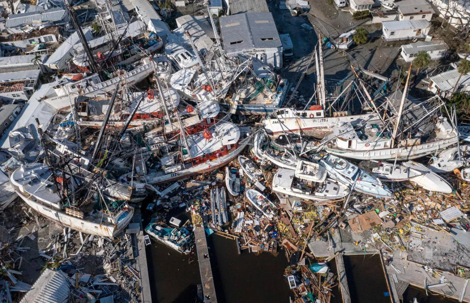 Boats are piled on top of each other in a marina near the bridge to Fort Myers after Hurricane Ian hit Sept. 28, 2022. Ian roared ashore at Cayo Costa as a Category 4 storm and caused $100 billion in damage.