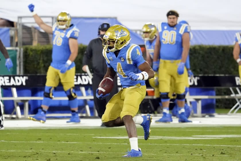 UCLA defensive back Stephan Blaylock (4) runs back after intercepting a pass against Arizona.