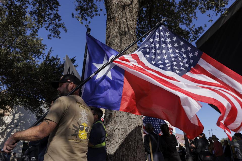 People protest Texas Gov. Greg Abbott’s immigration and border policies in Eagle Pass, Texas, in February 2024. <a href="https://www.gettyimages.com/detail/news-photo/counter-protesters-wave-flags-across-the-street-from-local-news-photo/1978653675?adppopup=true" rel="nofollow noopener" target="_blank" data-ylk="slk:Michael Gonzalez/Getty Images;elm:context_link;itc:0;sec:content-canvas" class="link ">Michael Gonzalez/Getty Images</a>