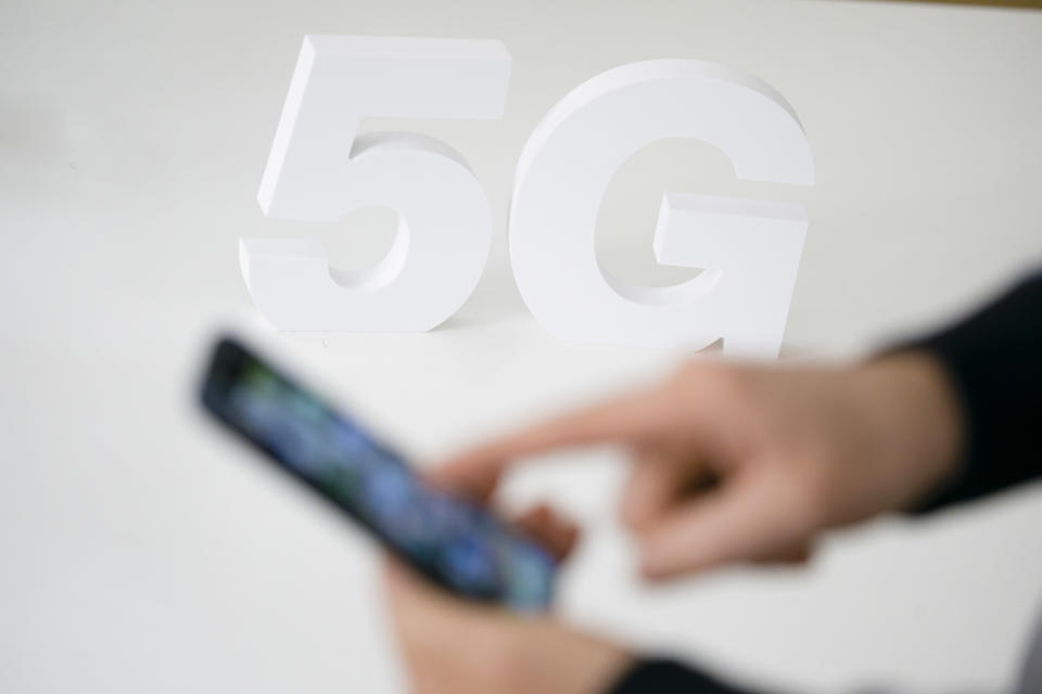 Berlin, Germany - April 12: Symbolic photo on the topic of mobile radio standard 5G. The lettering 5G stand on a table behind a smartphone on April 12, 2019 in Berlin, Germany. (Photo Illustration by Thomas Trutschel/Photothek via Getty Images)