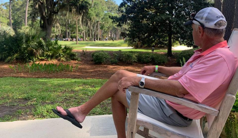 Renting a house in Sea Pines, Lyle Van Wyk watches golfers putt on hole 7 of the RBC Heritage from the comfort of his patio. Sebastian Lee