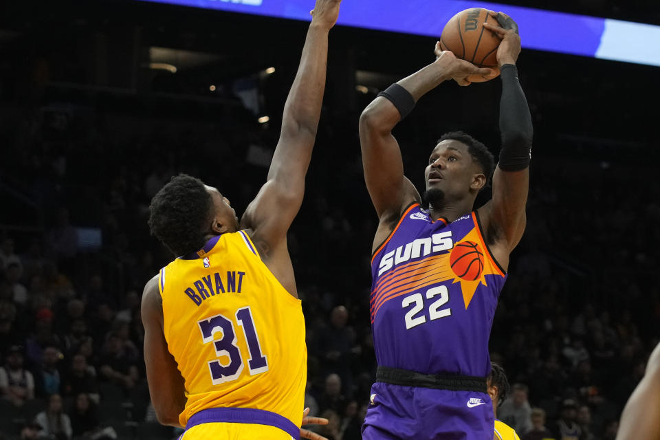 Phoenix Suns center Deandre Ayton shoots over Los Angeles Lakers center Thomas Bryant (31) during the second half of an NBA basketball game, Monday, Dec. 19, 2022, in Phoenix. (AP Photo/Rick Scuteri)