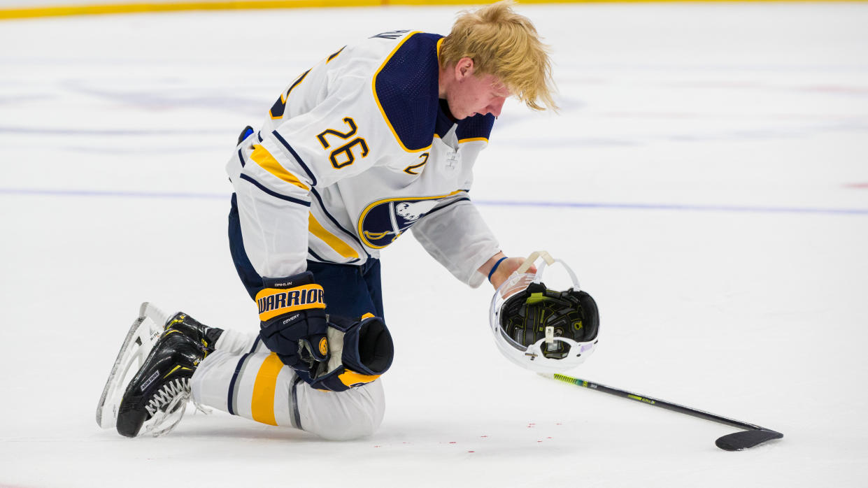Rasmus Dahlin of the Buffalo Sabres takes off his helmet after he starts bleeding during the second period against the Tampa Bay Lightning.  (Scott Audette /NHLI via Getty Images)