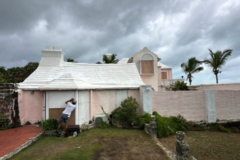 A man boarded up a house to protect it from the approaching Hurricane Ernesto in Warwick, Bermuda, on Friday. 