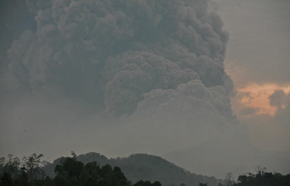 Mount Kelud erups, as seen from Mbalak village in Blitar East Java, Indonesia, Friday, Feb. 14, 2014. Volcanic ash from a major eruption in Indonesia shrouded a large swath of the country's most densely populated island on Friday, closed three international airports and sent thousands fleeing. (AP Photo/Trisnadi)