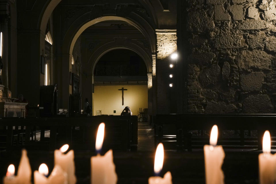 A person kneels in prayer during an Ash Wednesday service at the San Francisco Catholic church in Santiago, Chile, Wednesday, Feb. 14, 2024. Ash Wednesday marks the start of the Lenten season. (AP Photo/Esteban Felix)