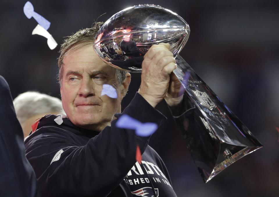 New England Patriots head coach Bill Belichick holds up the Vince Lombardi Trophy as he celebrates after the Patriots defeated the Seattle Seahawks 28-24 in NFL Super Bowl XLIX football game Sunday, Feb. 1, 2015, in Glendale, Ariz. (AP Photo/Patrick Semansky)