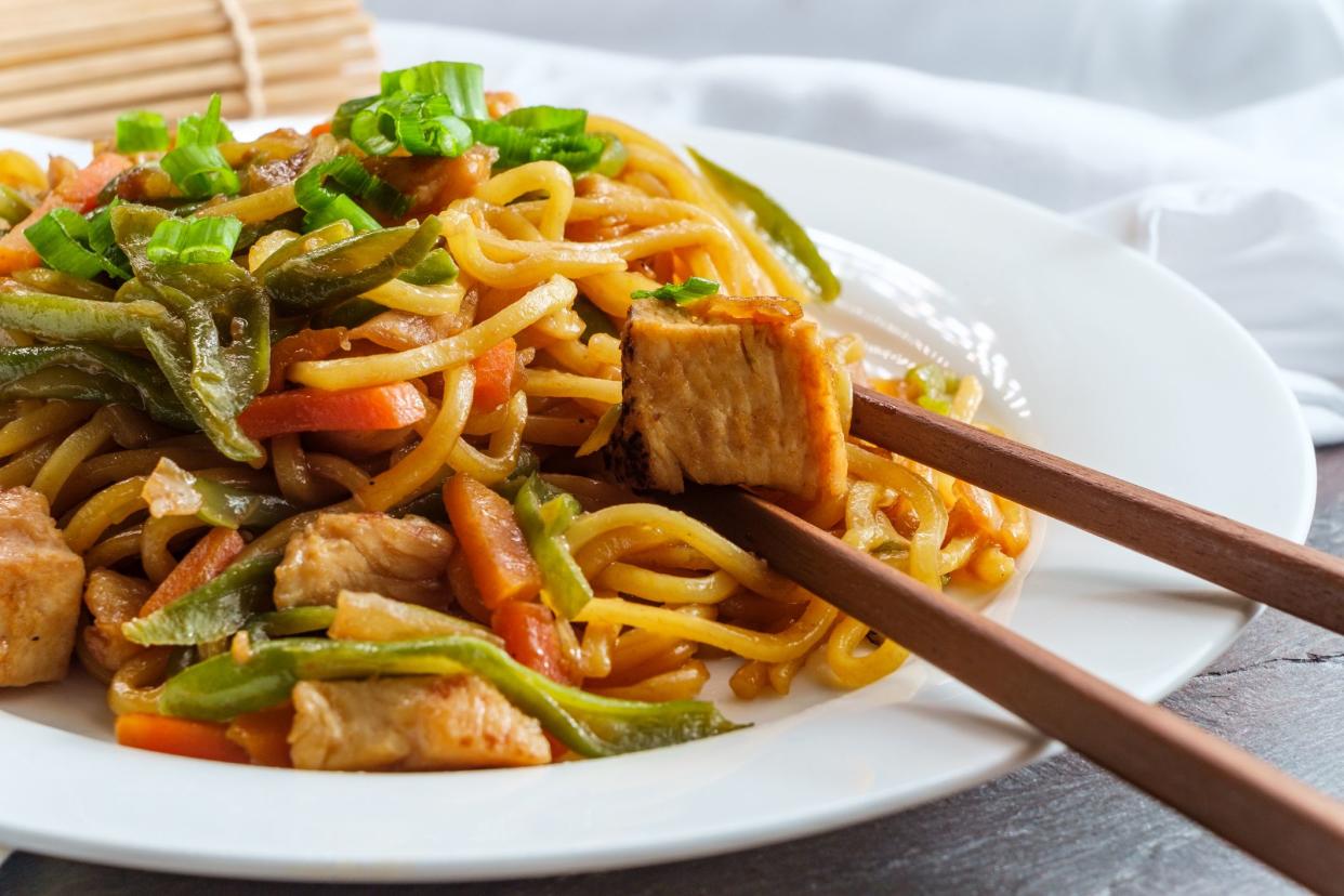 Eating Japanese chicken yakisoba noodles with chopsticks