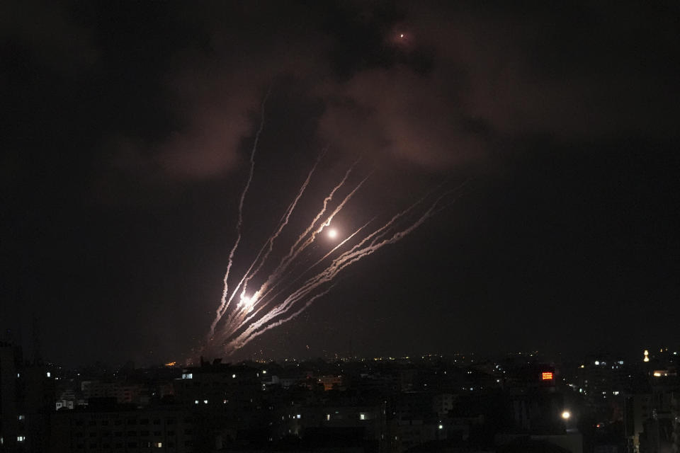 Rockets seen in the sky fired by Palestinian militants toward Israel, over Gaza City, Saturday, Aug. 6, 2022. The latest confrontation between Israel and Gaza militants is in its second day, as Israeli jets hit targets in Gaza and rocket fire persists into southern Israel. Palestinian officials say at least 15 people have been killed in Gaza, including a senior militant leader and a 5-year-old girl. (AP Photo/Adel Hana)