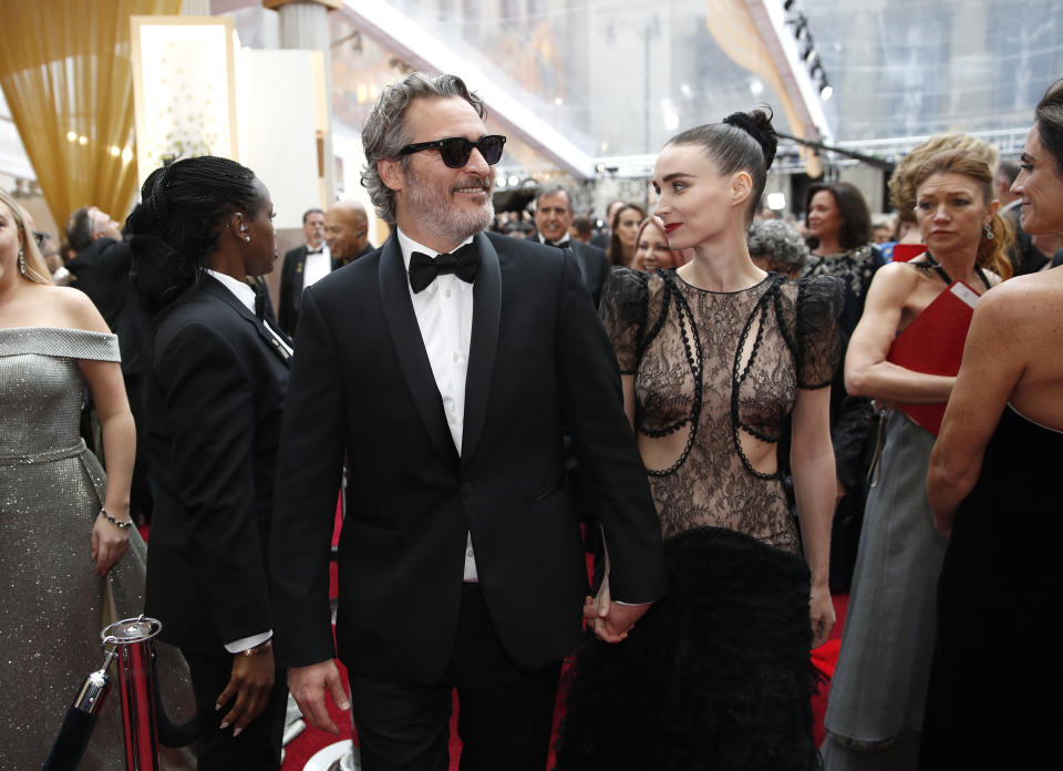 Joaquin Phoenix, left, and Rooney Mara arrive at the Oscars on Sunday, Feb. 9, 2020, at the Dolby Theatre in Los Angeles. (AP Photo/John Locher)