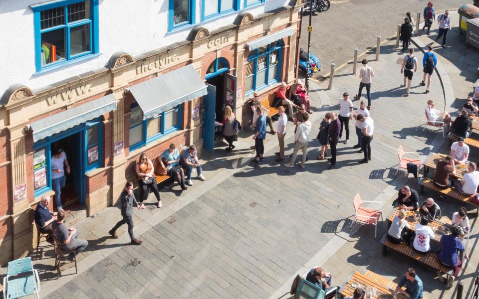 people drinking outside a pub