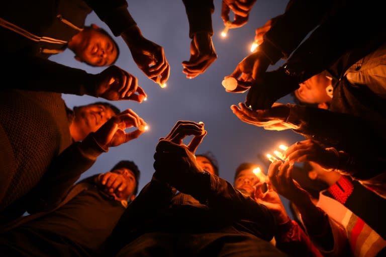 Nepali people hold a candlelight vigil for the plane crash victims in Kathmandu