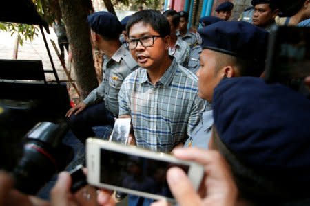 Detained Reuters journalist Wa Lone talks to reporters after a court hearing in Yangon, Myanmar March 14, 2018. REUTERS/Stringer
