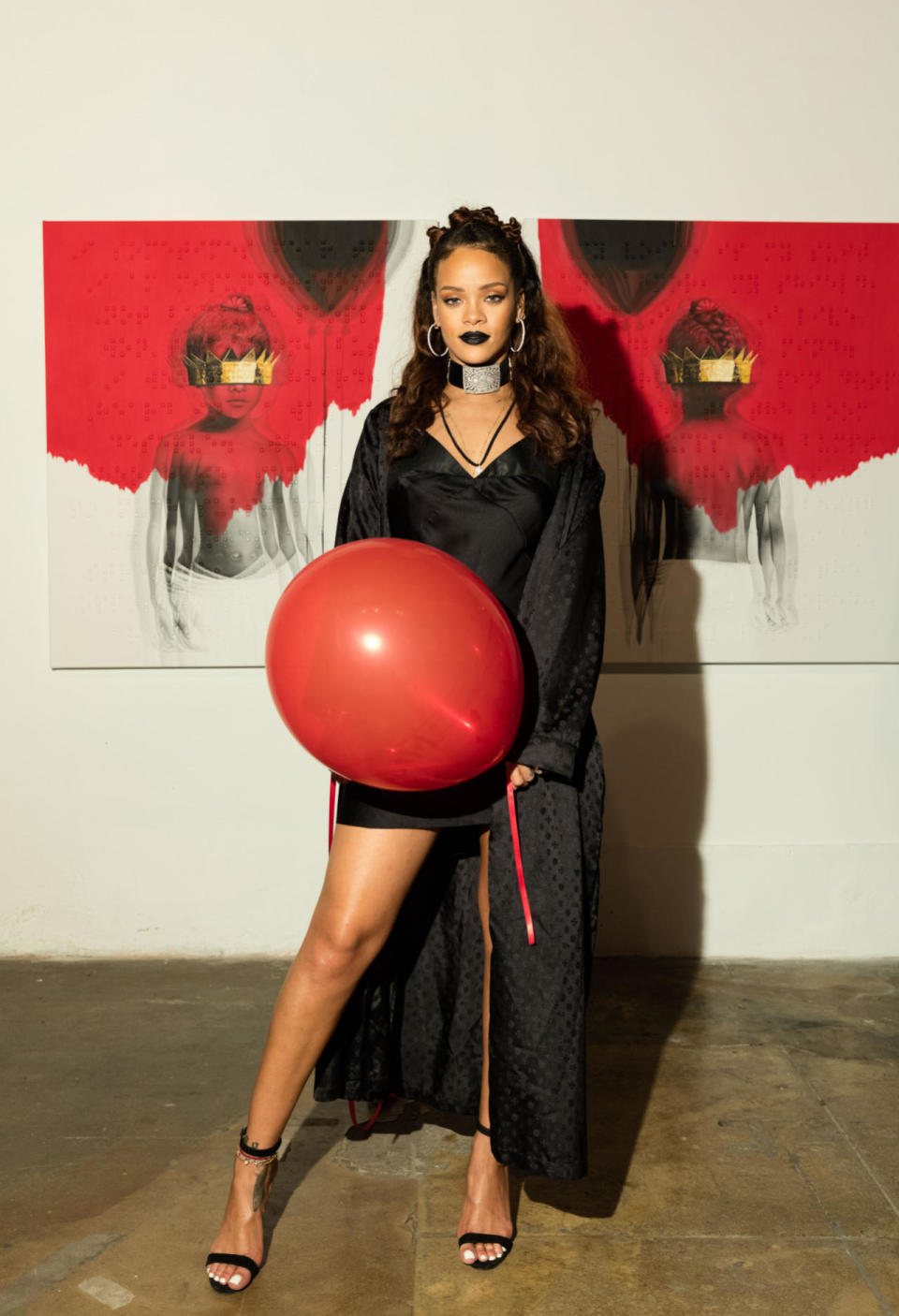 Rihanna wears a black slip dress and robe to unveil the album art for ANTI at MAMA Gallery on Oct. 7, 2015 in Los Angeles.